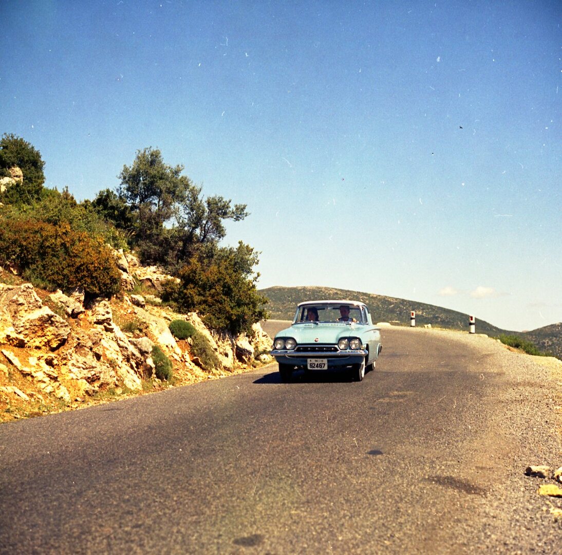 This archival image documents the 1961 Ford Classic and Consul 315 on scenic road in Greece and is preserved in the Ford Heritage Vault as part of Ford Motor Company's historic photographic archive. Free for personal, non-commercial use. Ford Heri...