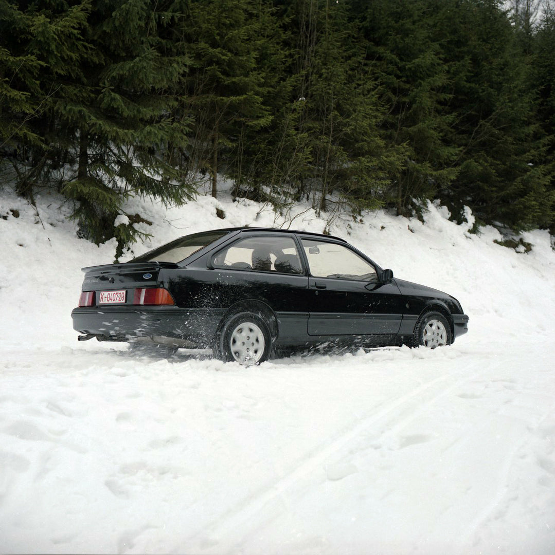 This archival image documents the 1985 Ford Sierra XR 4x4 LHD rear view action shot on snowy road and is preserved in the Ford Heritage Vault as part of Ford Motor Company's historic photographic archive. Free for personal, non-commercial use. For...