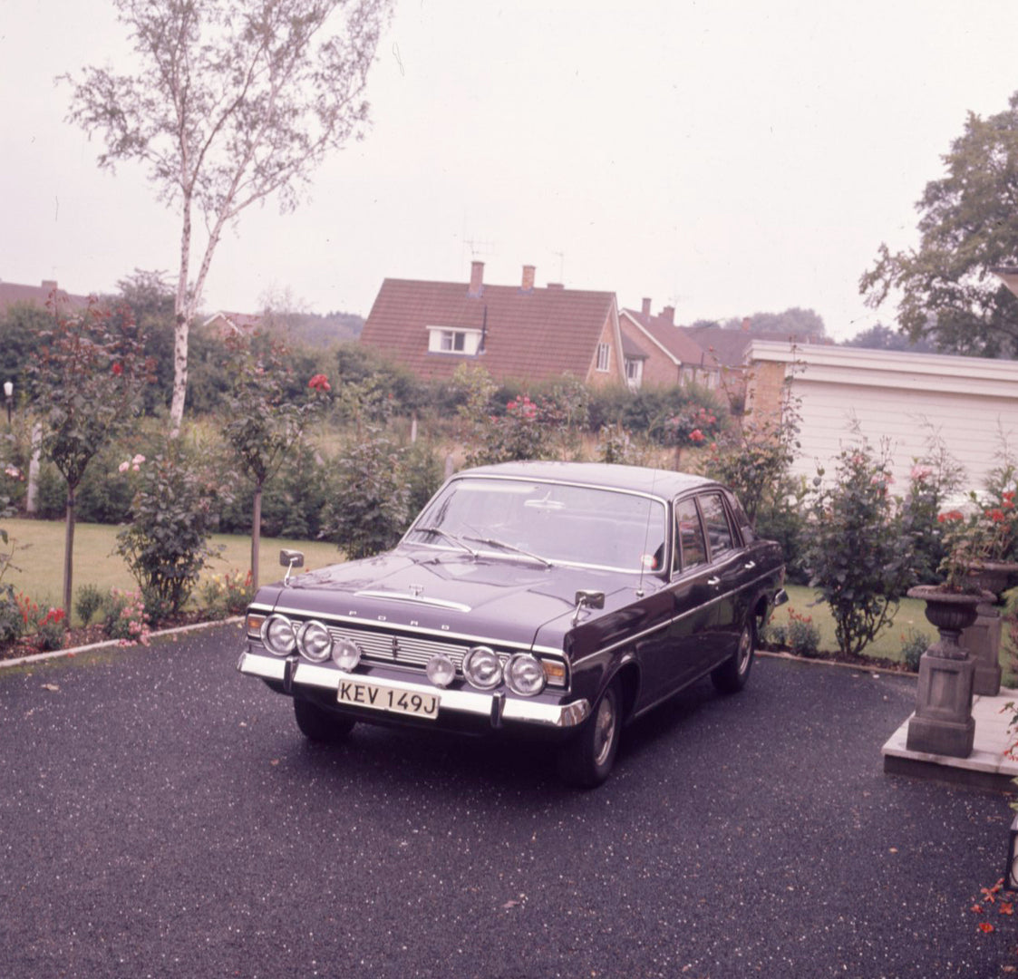 This archival image documents the 1970 Ford Zodiac Mark IV Executive front view in scenic driveway with flowers and is preserved in the Ford Heritage Vault as part of Ford Motor Company's historic photographic archive. Free for personal, non-comme...