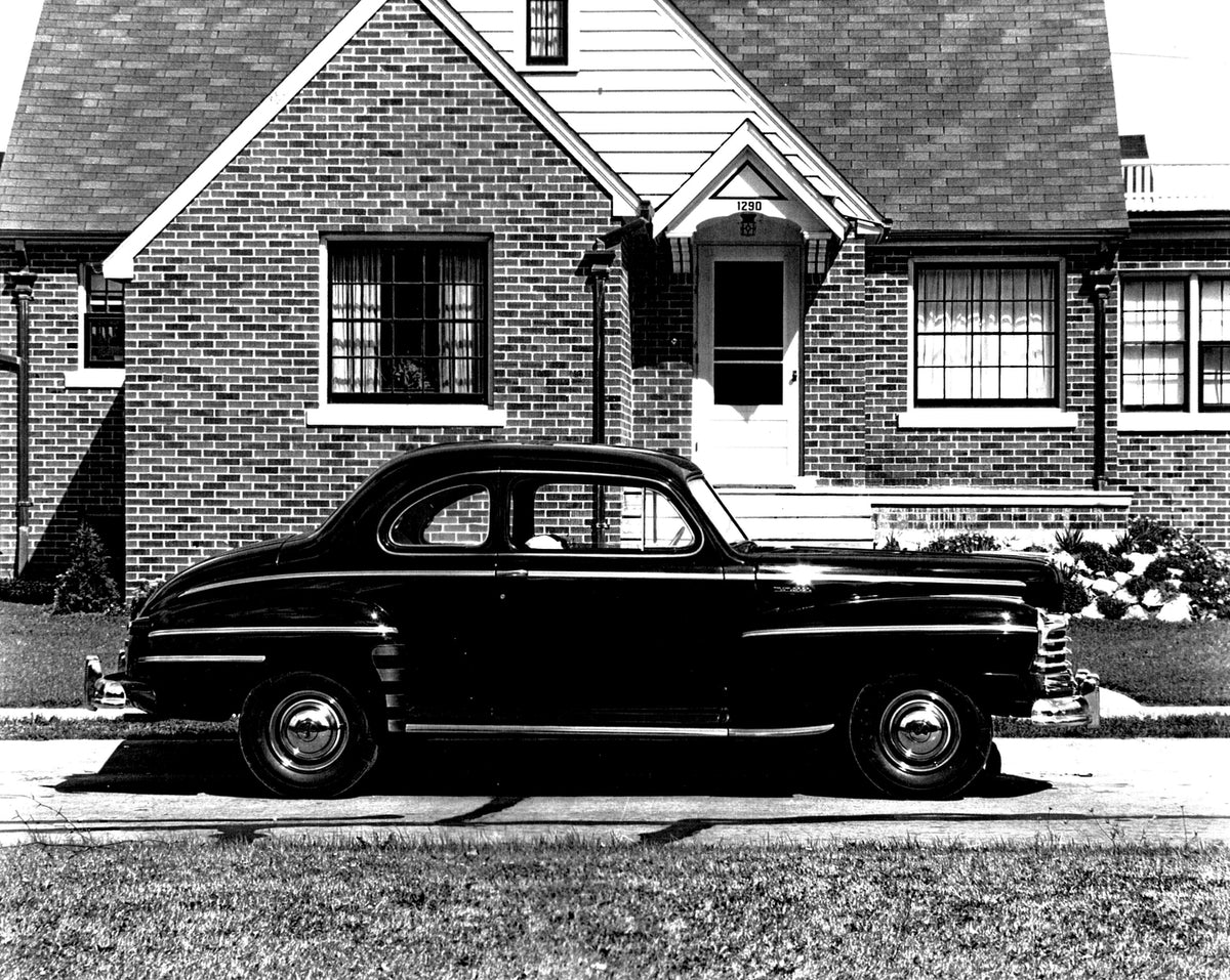 This archival image documents the 1946 Monarch Coupe side view in front of house AR-2007-5 and is preserved in the Ford Heritage Vault as part of Ford Motor Company's historic photographic archive. Free for personal, non-commercial use. Ford Herit...