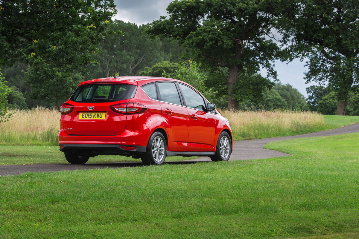 This archival image documents the 2015 Ford C-Max Mark II rear view on scenic road with trees and is preserved in the Ford Heritage Vault as part of Ford Motor Company's historic photographic archive. Free for personal, non-commercial use. Ford He...