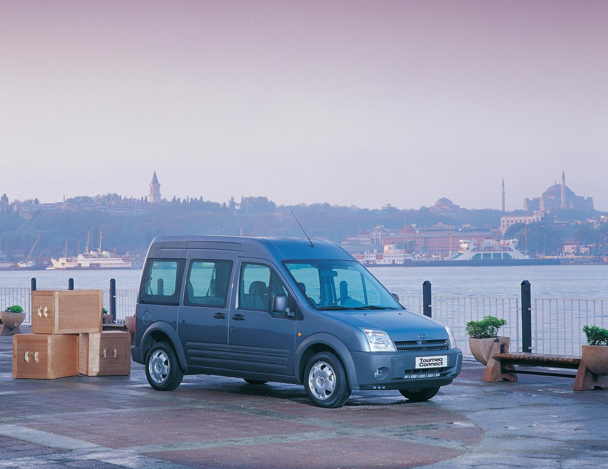 This archival image documents the 2002 Ford Transit Connect with scenic lake and city skyline and is preserved in the Ford Heritage Vault as part of Ford Motor Company's historic photographic archive. Free for personal, non-commercial use. Ford He...