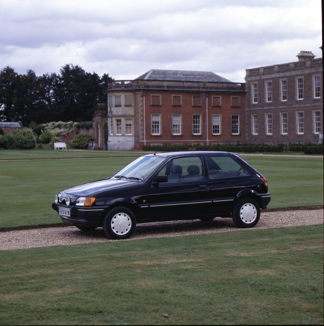 This archival image documents the 1988 Ford Fiesta Mark III side view in scenic driveway at Blickling Hall and is preserved in the Ford Heritage Vault as part of Ford Motor Company's historic photographic archive. Free for personal, non-commercial...