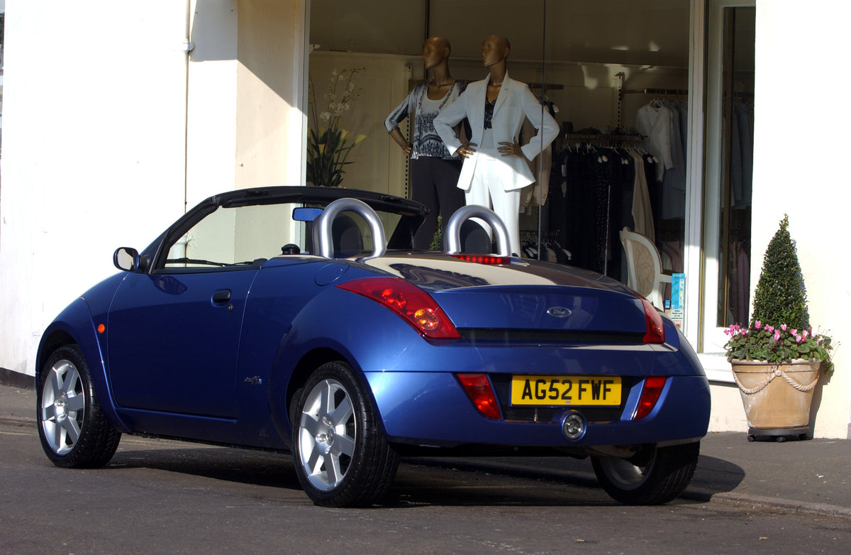 This archival image documents the 2003 Ford Street Ka Mark I rear view in front of clothing store and is preserved in the Ford Heritage Vault as part of Ford Motor Company's historic photographic archive. Free for personal, non-commercial use. For...