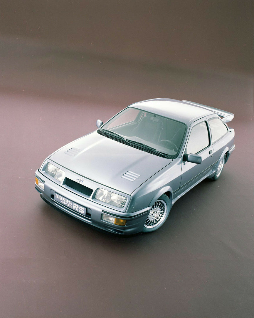 This archival image documents the 1985 Ford Sierra RS Cosworth aerial view in studio and is preserved in the Ford Heritage Vault as part of Ford Motor Company's historic photographic archive. Free for personal, non-commercial use. Ford Heritage Va...