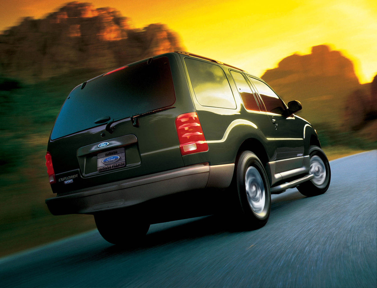 This archival image documents the 2002 Ford Explorer Sport rear view action shot on scenic road with mountains MS938 and is preserved in the Ford Heritage Vault as part of Ford Motor Company's historic photographic archive. Free for personal, non-...