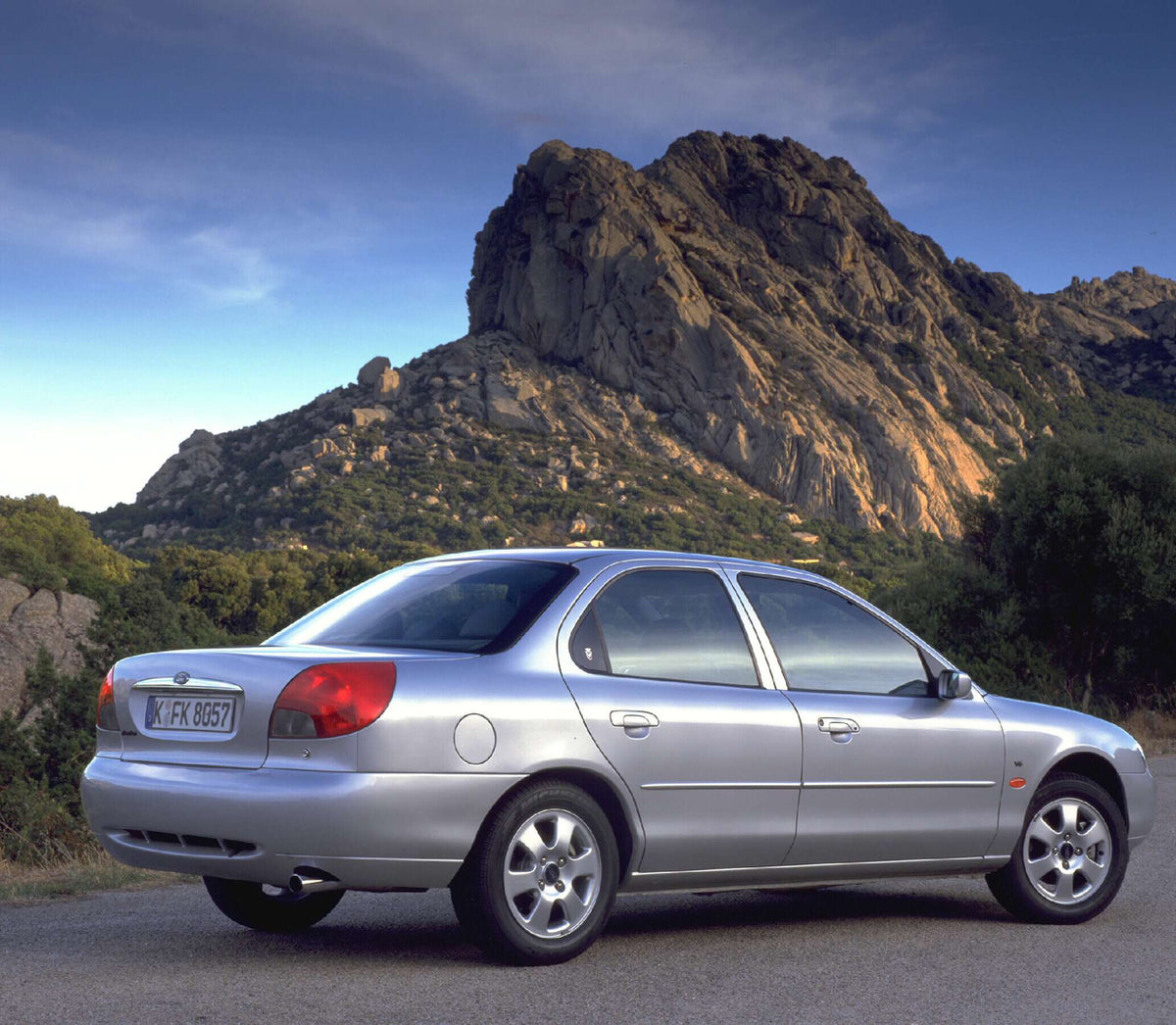 This archival image documents the 1996 Ford Mondeo Mark II Ghia rear view with scenic mountains and is preserved in the Ford Heritage Vault as part of Ford Motor Company's historic photographic archive. Free for personal, non-commercial use. Ford ...