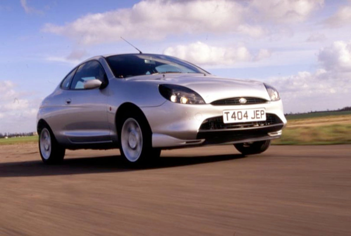 This archival image documents the 1999 Ford Puma 1.4 action shot on scenic road and is preserved in the Ford Heritage Vault as part of Ford Motor Company's historic photographic archive. Free for personal, non-commercial use. Ford Heritage Vault r...