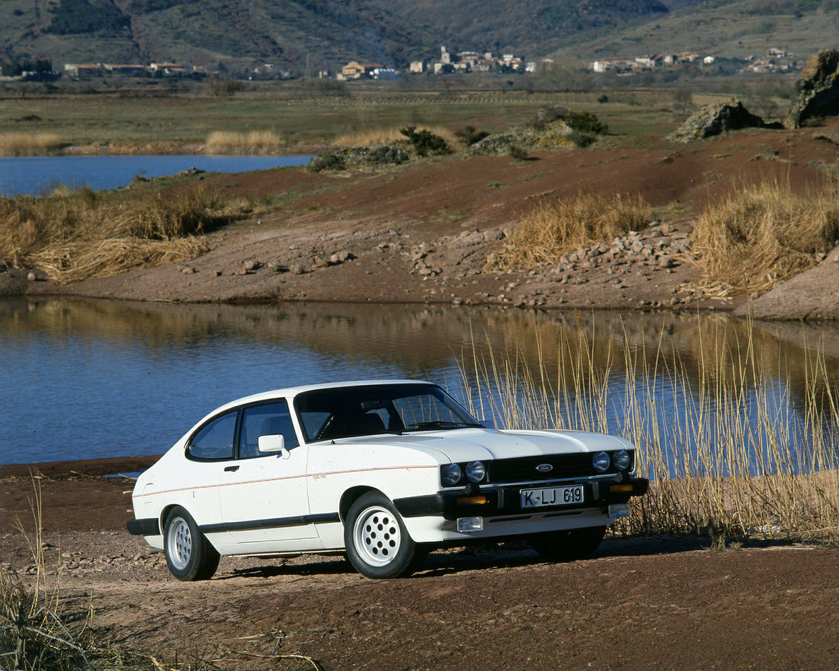 This archival image documents the 1981 Ford Capri Mark III LHD 2.8 Injection with pond and mountains in background and is preserved in the Ford Heritage Vault as part of Ford Motor Company's historic photographic archive. Free for personal, non-co...