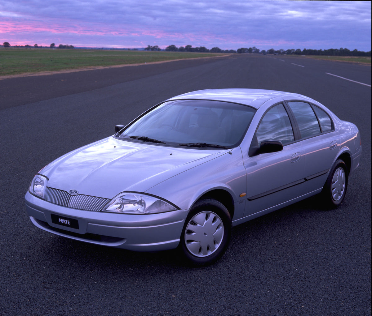 This archival image documents the 1998 Ford Falcon Forte on road with scenic sunset sky and is preserved in the Ford Heritage Vault as part of Ford Motor Company's historic photographic archive. Free for personal, non-commercial use. Ford Heritage...