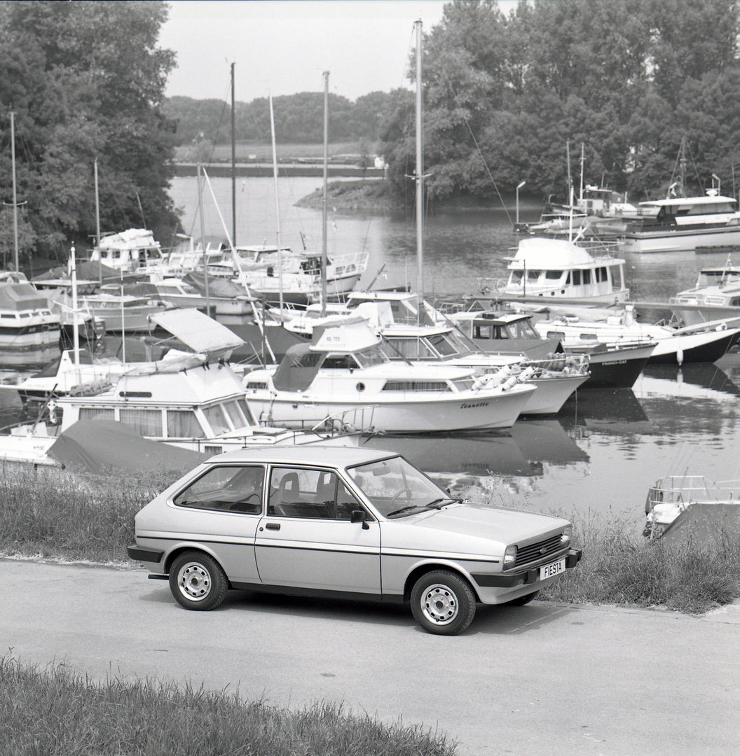 This archival image documents the 1981 Ford Fiesta Mark I RHD Ghia GL near harbor with boats and is preserved in the Ford Heritage Vault as part of Ford Motor Company's historic photographic archive. Free for personal, non-commercial use. Ford Her...