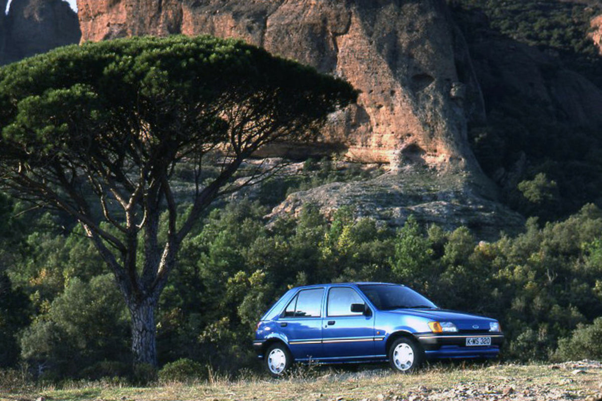 This archival image documents the 1989 Ford Fiesta Mark III LHD with scenic tree and mountains and is preserved in the Ford Heritage Vault as part of Ford Motor Company's historic photographic archive. Free for personal, non-commercial use. Ford H...