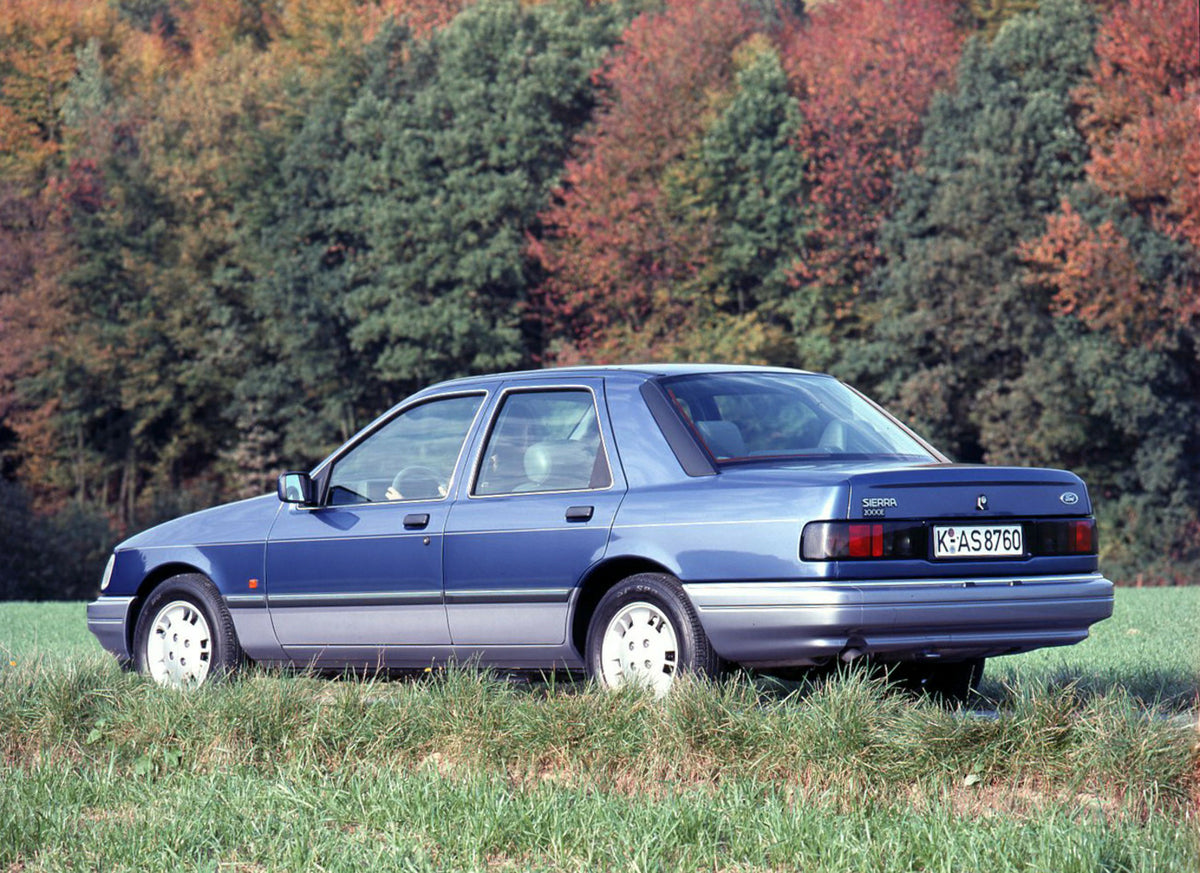 This archival image documents the 1989 Ford Sierra 2000E rear view with scenic trees and is preserved in the Ford Heritage Vault as part of Ford Motor Company's historic photographic archive. Free for personal, non-commercial use. Ford Heritage Va...