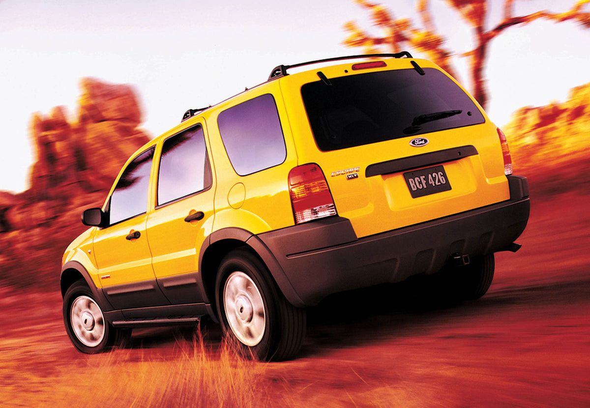This archival image documents the 2002 Ford Escape rear view action shot in scenic desert MS9731 and is preserved in the Ford Heritage Vault as part of Ford Motor Company's historic photographic archive. Free for personal, non-commercial use. Ford...
