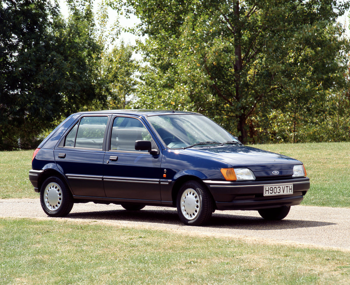 This archival image documents the 1990 Ford Fiesta Mark III Ghia with scenic trees and is preserved in the Ford Heritage Vault as part of Ford Motor Company's historic photographic archive. Free for personal, non-commercial use. Ford Heritage Vaul...
