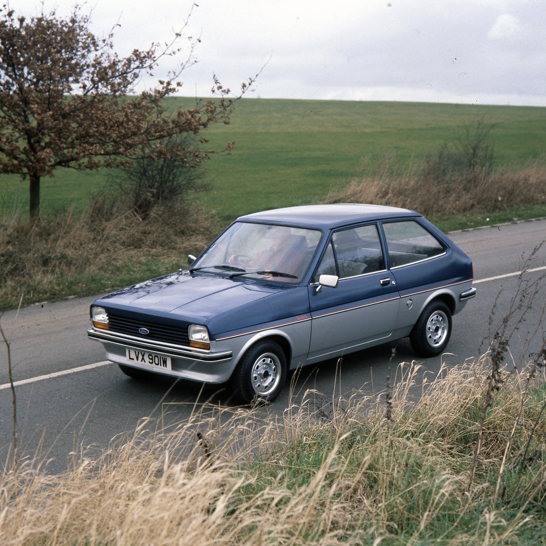 This archival image documents the 1981 Ford Fiesta Mark I Bravo on scenic road with field and is preserved in the Ford Heritage Vault as part of Ford Motor Company's historic photographic archive. Free for personal, non-commercial use. Ford Herita...