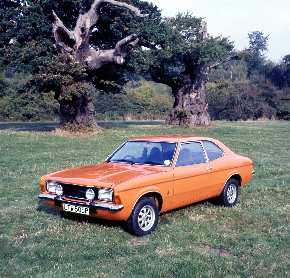 This archival image documents the 1975 Ford Cortina MK III GT 2.0 in scenic field with trees and is preserved in the Ford Heritage Vault as part of Ford Motor Company's historic photographic archive. Free for personal, non-commercial use. Ford Her...