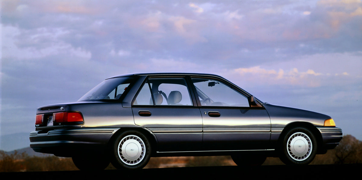 This archival image documents the 1993 Ford Escort four-door and is preserved in the Ford Heritage Vault as part of Ford Motor Company's historic photographic archive. Free for personal, non-commercial use. Ford Heritage Vault reference AR-2001-94...