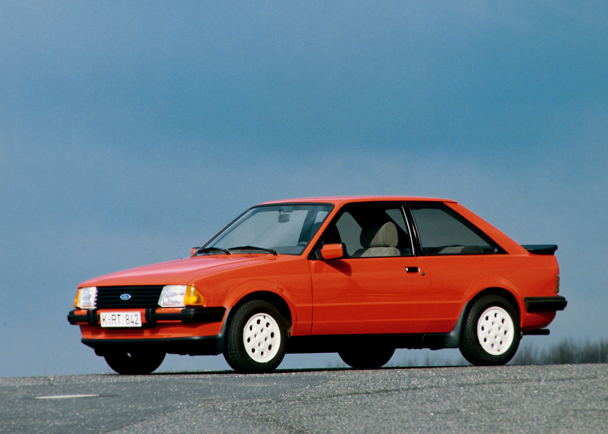 This archival image documents the 1984 Ford Escort Mark III XR3i with scenic blue sky and is preserved in the Ford Heritage Vault as part of Ford Motor Company's historic photographic archive. Free for personal, non-commercial use. Ford Heritage V...