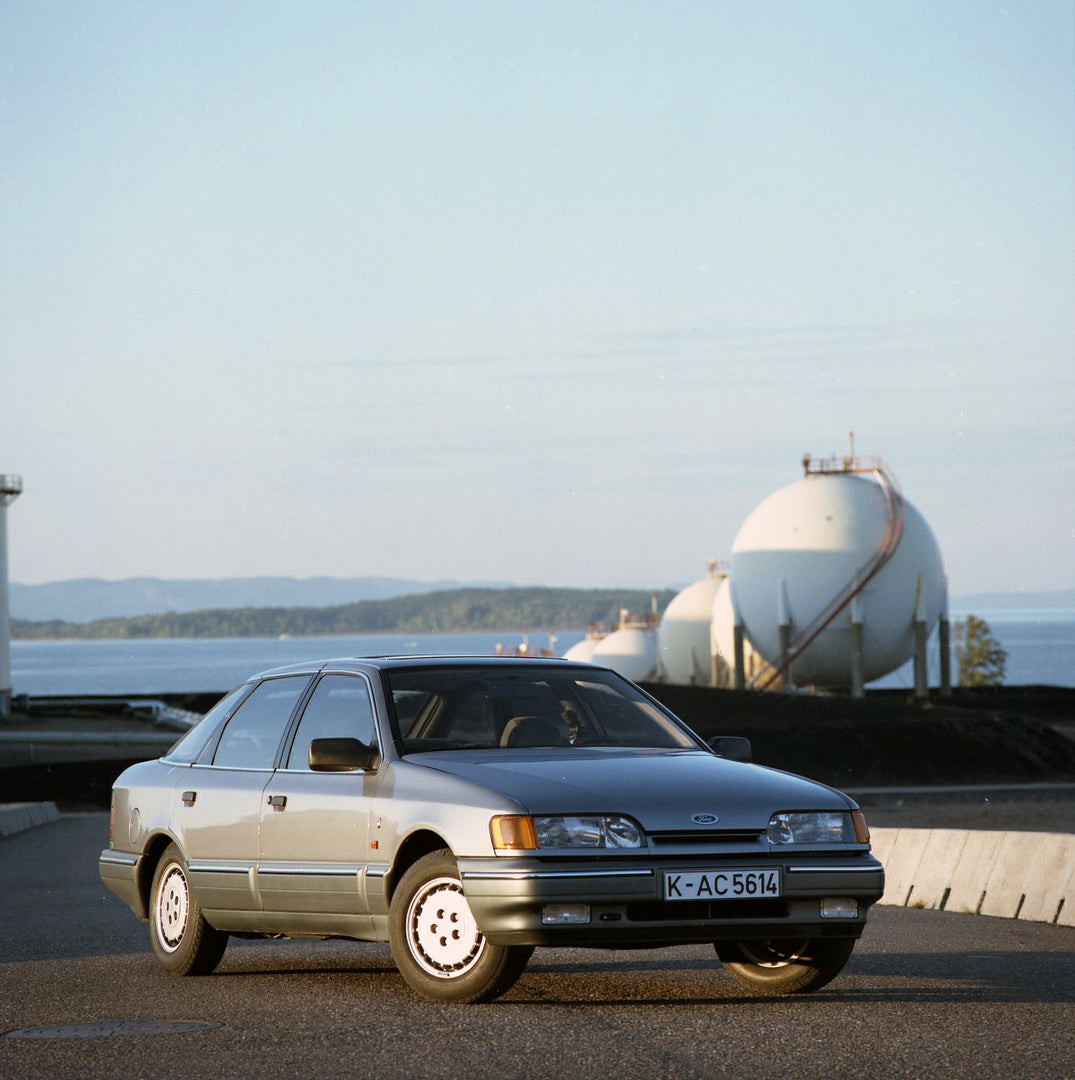 This archival image documents the 1986 Ford Granada Mark III Ghia on scenic road in Norway and is preserved in the Ford Heritage Vault as part of Ford Motor Company's historic photographic archive. Free for personal, non-commercial use. Ford Herit...
