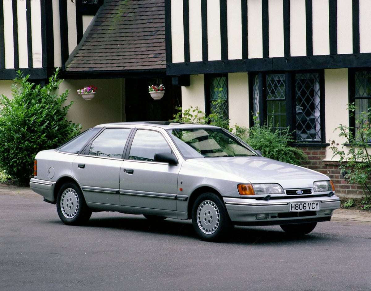 This archival image documents the 1990 Ford Granada MK III Ghia X in front of scenic house and is preserved in the Ford Heritage Vault as part of Ford Motor Company's historic photographic archive. Free for personal, non-commercial use. Ford Herit...