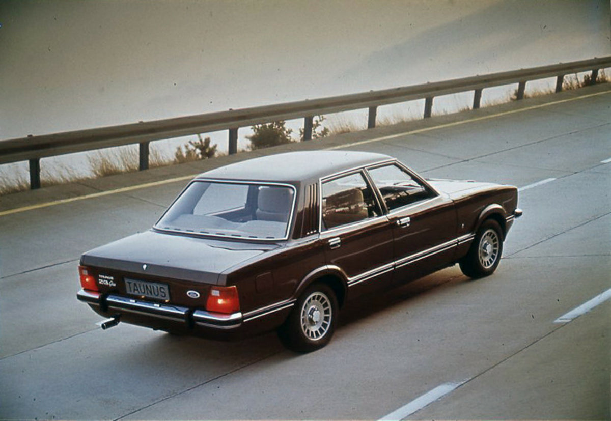 This archival image documents the 1976 Ford Taunus 2.3 Ghia rear view on road and is preserved in the Ford Heritage Vault as part of Ford Motor Company's historic photographic archive. Free for personal, non-commercial use. Ford Heritage Vault ref...