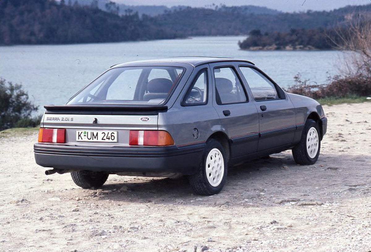 This archival image documents the 1985 Ford Sierra 2.0 IS LHD rear view on scenic beach and is preserved in the Ford Heritage Vault as part of Ford Motor Company's historic photographic archive. Free for personal, non-commercial use. Ford Heritage...