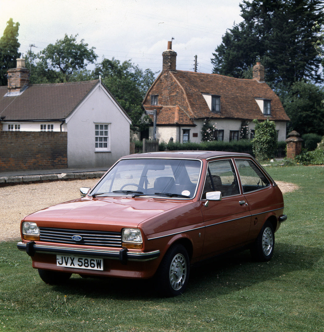This archival image documents the 1980 Ford Fiesta Mark I Ghia 1.1 Litre in front of scenic houses and is preserved in the Ford Heritage Vault as part of Ford Motor Company's historic photographic archive. Free for personal, non-commercial use. Fo...