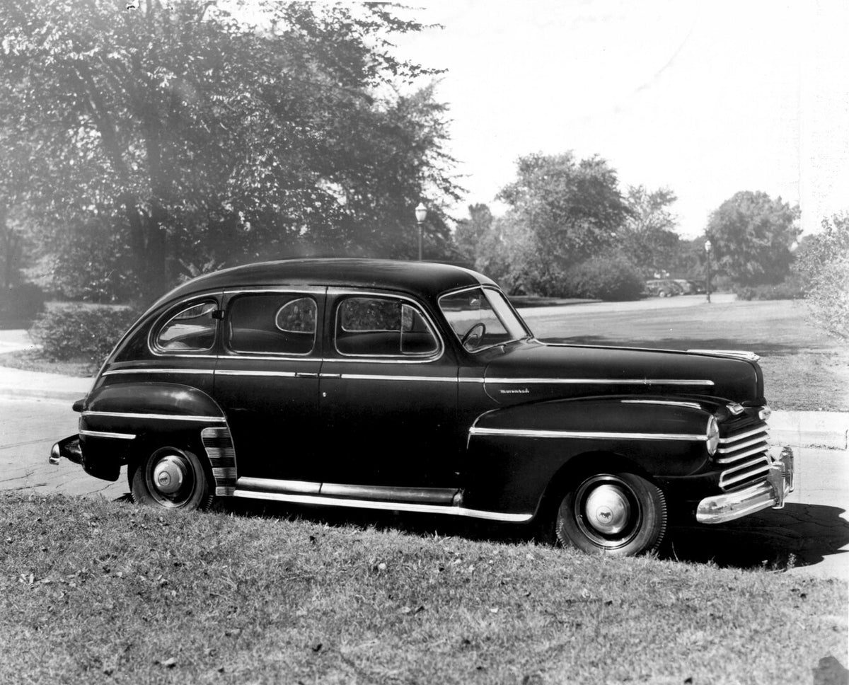 This archival image documents the 1946 Monarch Sedan on scenic road with trees AR-2007-5 and is preserved in the Ford Heritage Vault as part of Ford Motor Company's historic photographic archive. Free for personal, non-commercial use. Ford Heritag...