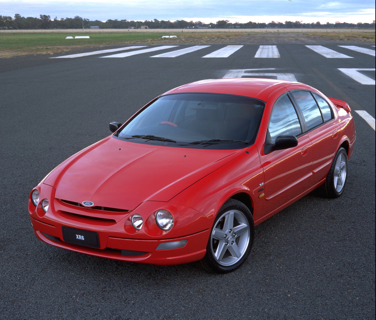 This archival image documents the 1998 Ford Falcon XR6 on road with scenic trees in distance and is preserved in the Ford Heritage Vault as part of Ford Motor Company's historic photographic archive. Free for personal, non-commercial use. Ford Her...