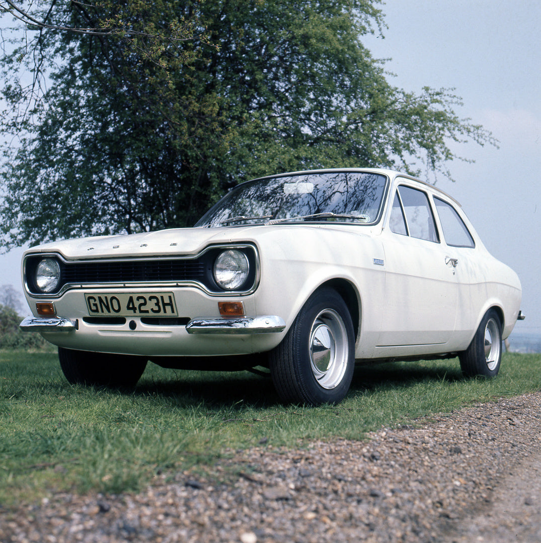 This archival image documents the 1970 Ford Escort Mark I Belt Drive, A Type in scenic field with tree and is preserved in the Ford Heritage Vault as part of Ford Motor Company's historic photographic archive. Free for personal, non-commercial use...