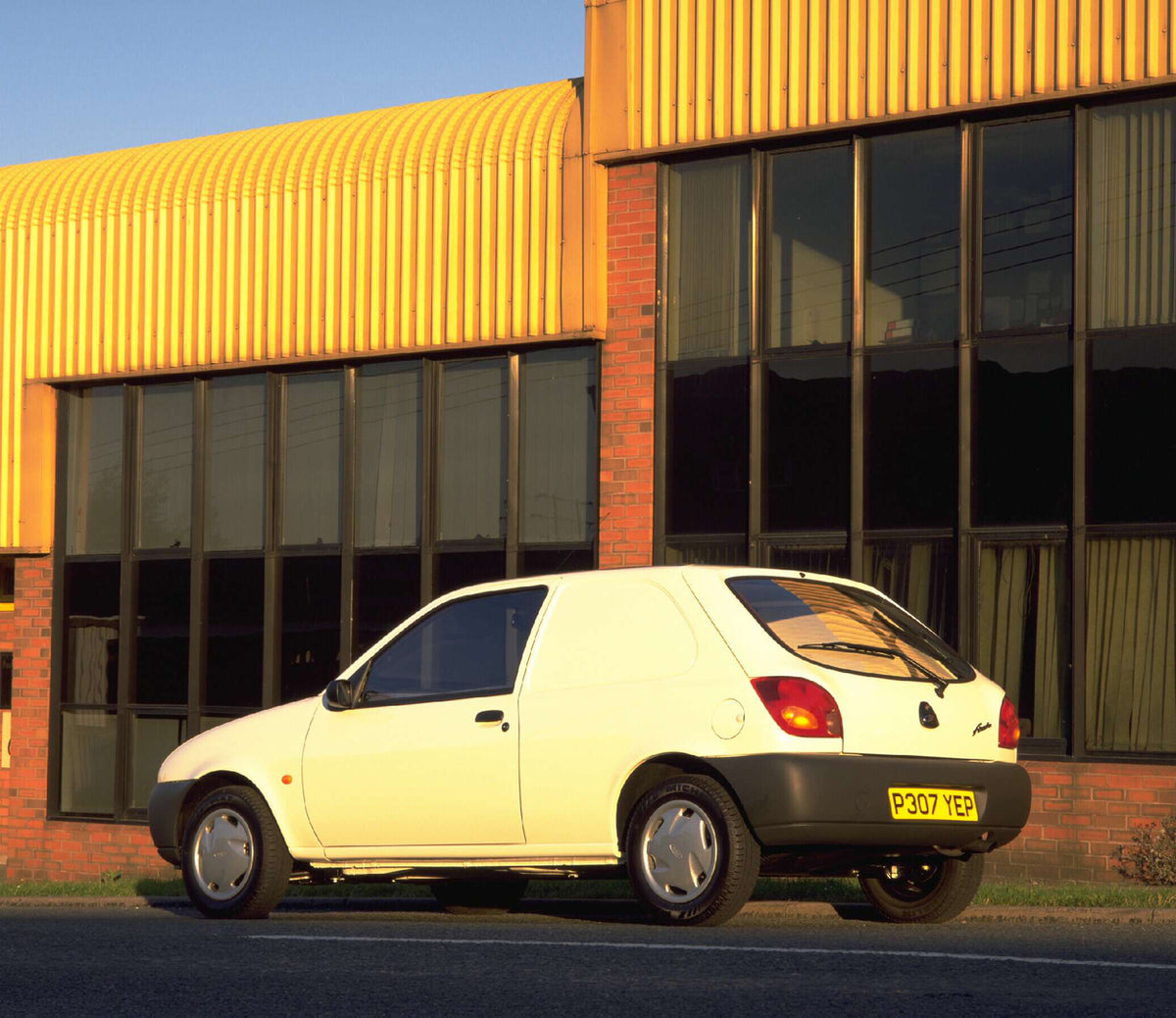 This archival image documents the 1996 Ford Fiesta Mark IV Courier 35 Van rear view in front of building AR-2002-213709 and is preserved in the Ford Heritage Vault as part of Ford Motor Company's historic photographic archive. Free for personal, n...