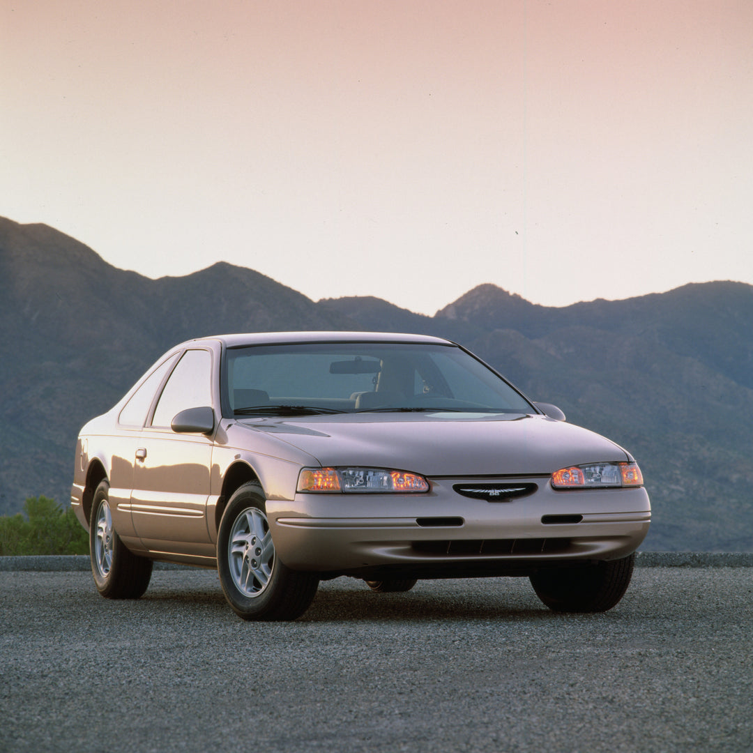 This archival image documents the 1997 Ford Thunderbird LX scenic in mountains and is preserved in the Ford Heritage Vault as part of Ford Motor Company's historic photographic archive. Free for personal, non-commercial use. Ford Heritage Vault re...