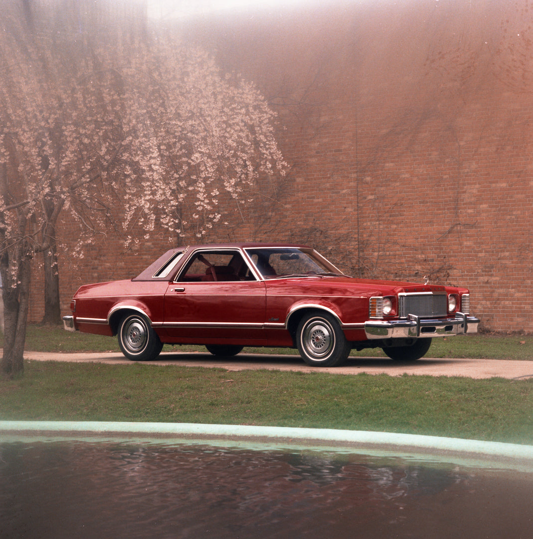 This archival image documents the 1975 Mercury Monarch with blurred scenic background and is preserved in the Ford Heritage Vault as part of Ford Motor Company's historic photographic archive. Free for personal, non-commercial use. Ford Heritage V...