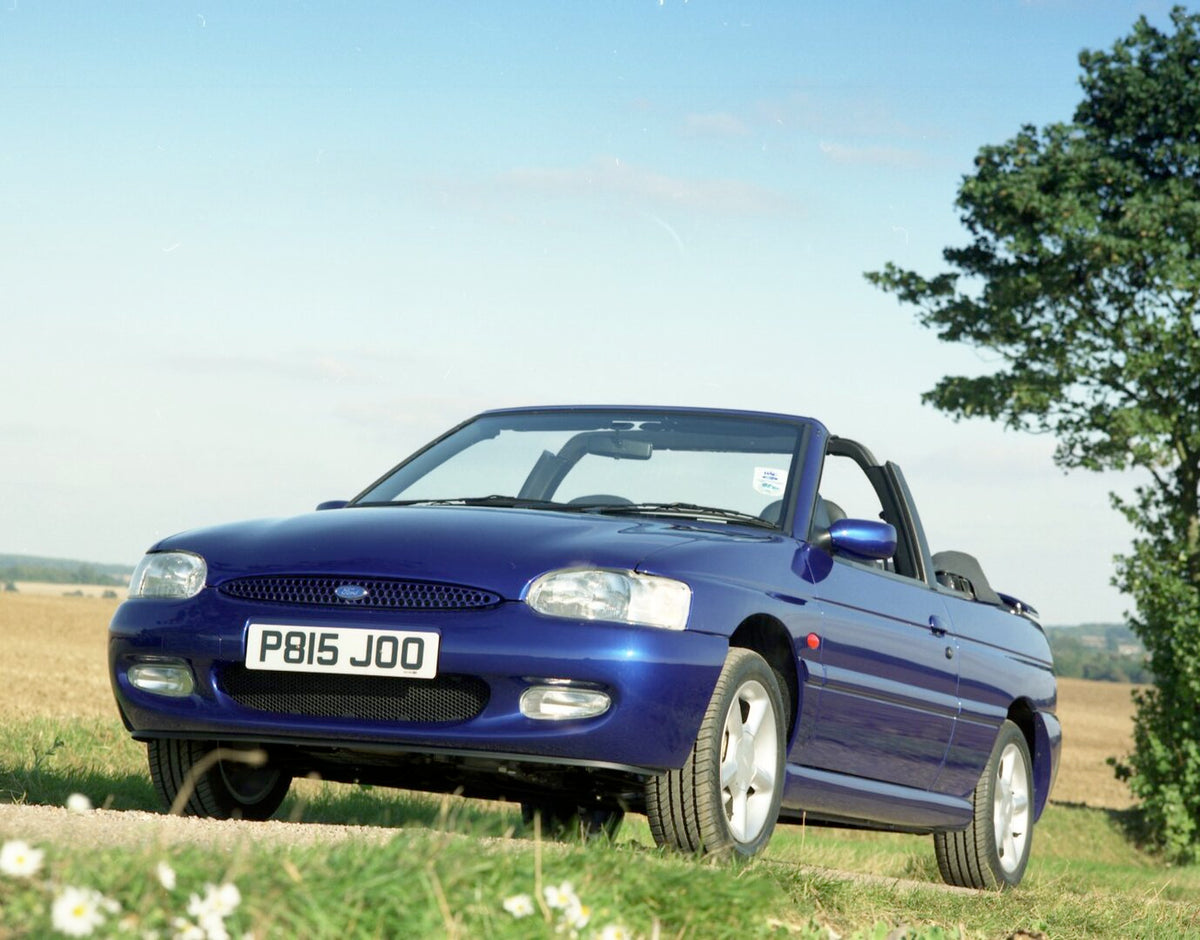 This archival image documents the 1996 Ford Escort Mark VI Cabriolet Ghia low view on scenic road and is preserved in the Ford Heritage Vault as part of Ford Motor Company's historic photographic archive. Free for personal, non-commercial use. For...