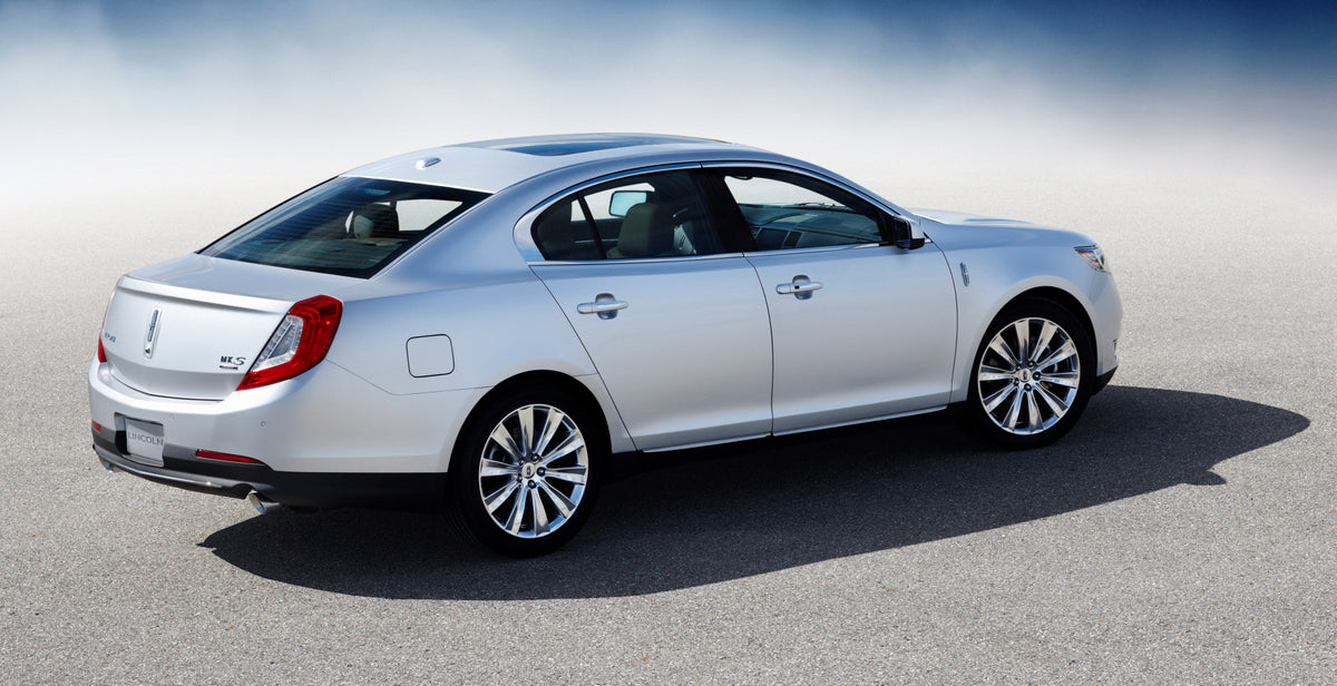 This archival image documents the 2013 Lincoln MKS rear view with mist MS7535 and is preserved in the Ford Heritage Vault as part of Ford Motor Company's historic photographic archive. Free for personal, non-commercial use. Ford Heritage Vault ref...
