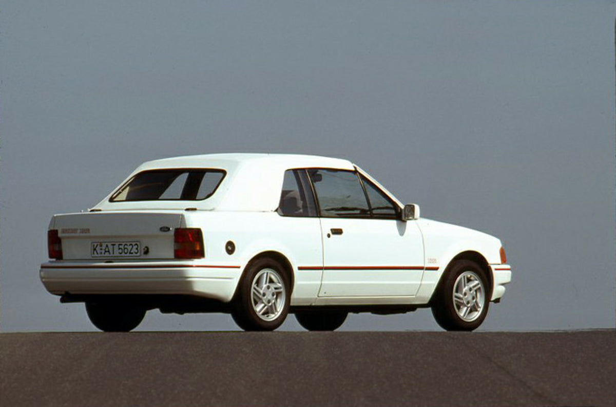This archival image documents the 1989 Ford Escort Mark IV Cabriolet LHD rear view with scenic blue sky and is preserved in the Ford Heritage Vault as part of Ford Motor Company's historic photographic archive. Free for personal, non-commercial us...