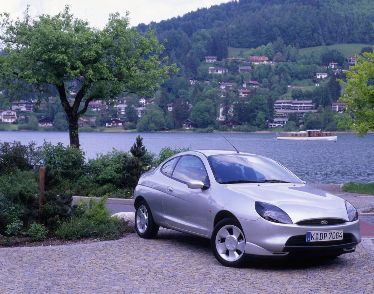This archival image documents the 1997 Ford Puma LHD with scenic lake and trees in Germany and is preserved in the Ford Heritage Vault as part of Ford Motor Company's historic photographic archive. Free for personal, non-commercial use. Ford Herit...