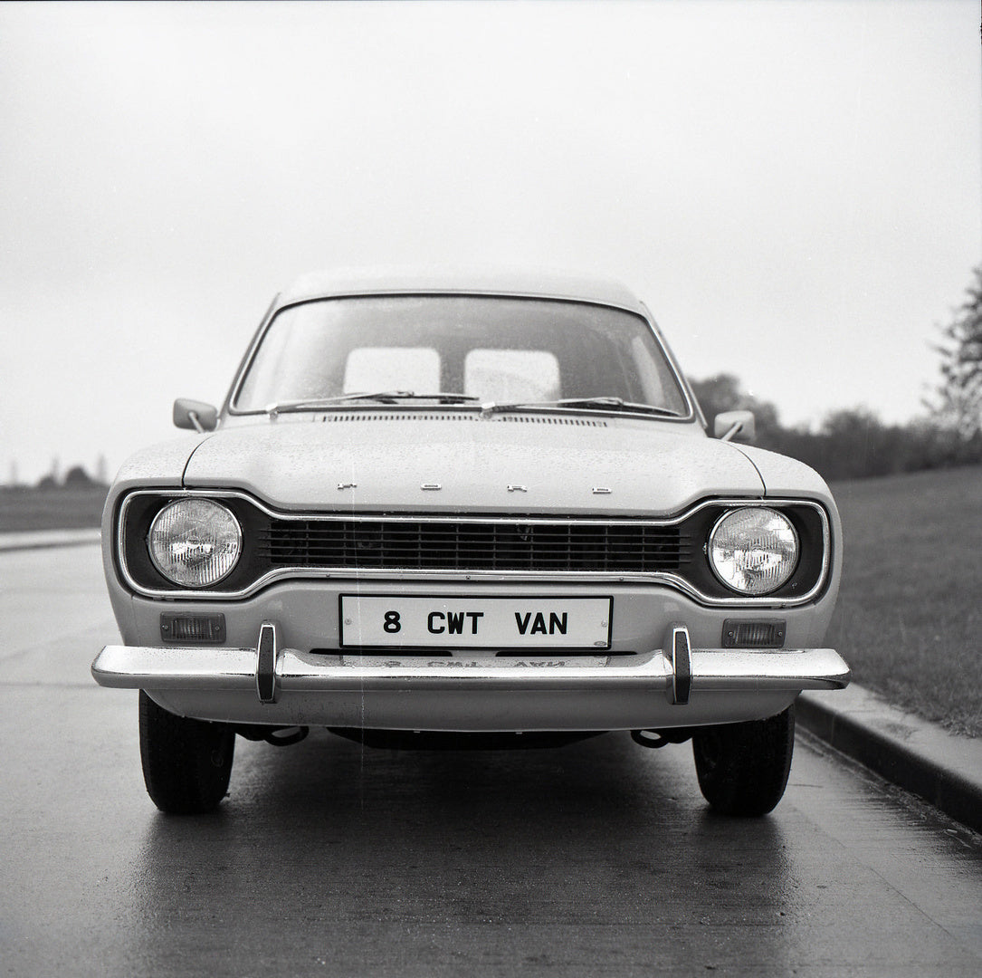 This archival image documents the 1974 Ford Escort Mark II 6 to 8 Counterweight Van front view on scenic road and is preserved in the Ford Heritage Vault as part of Ford Motor Company's historic photographic archive. Free for personal, non-commerc...