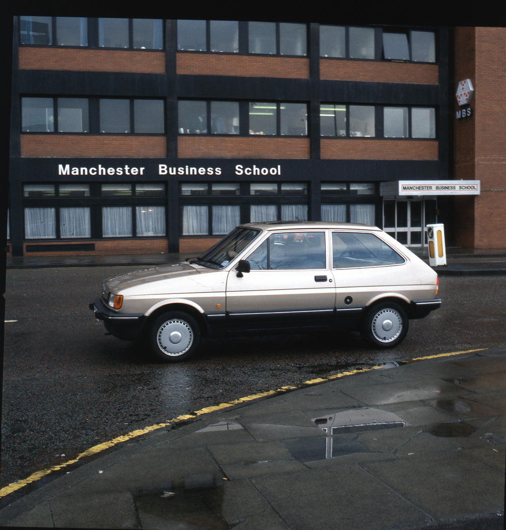 This archival image documents the 1987 Ford Fiesta Mark II CTX 1.1 Ghia side view in front of Manchester Business School and is preserved in the Ford Heritage Vault as part of Ford Motor Company's historic photographic archive. Free for personal, ...