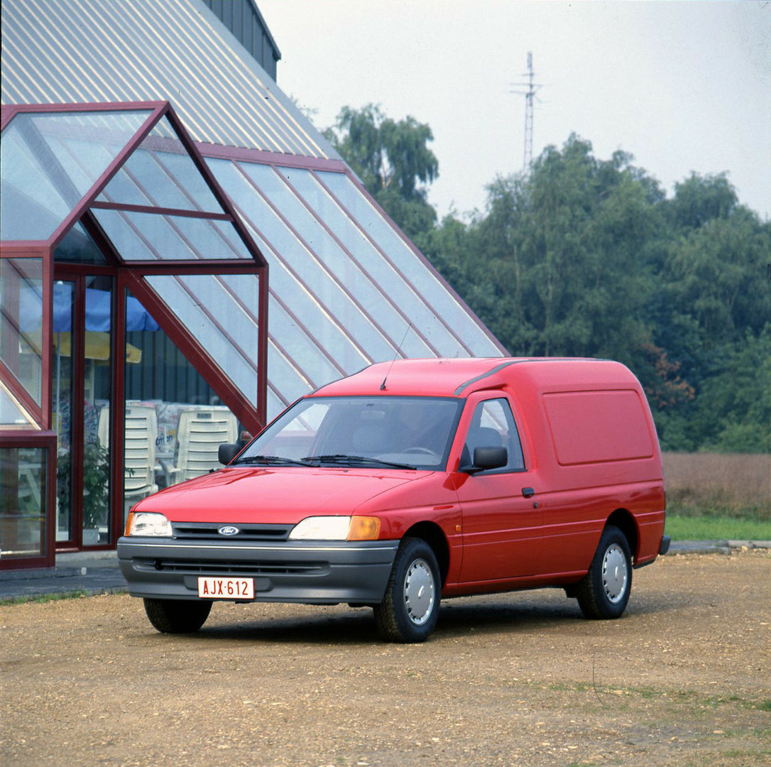 This archival image documents the 1990 Ford Escort Mark IV van next to building and is preserved in the Ford Heritage Vault as part of Ford Motor Company's historic photographic archive. Free for personal, non-commercial use. Ford Heritage Vault r...
