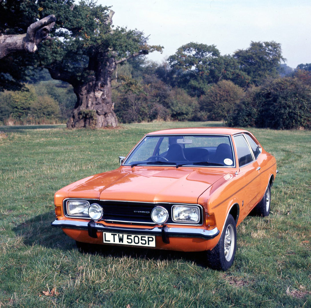 This archival image documents the 1975 Ford Cortina MK III GT 2.0 in scenic field with trees and is preserved in the Ford Heritage Vault as part of Ford Motor Company's historic photographic archive. Free for personal, non-commercial use. Ford Her...