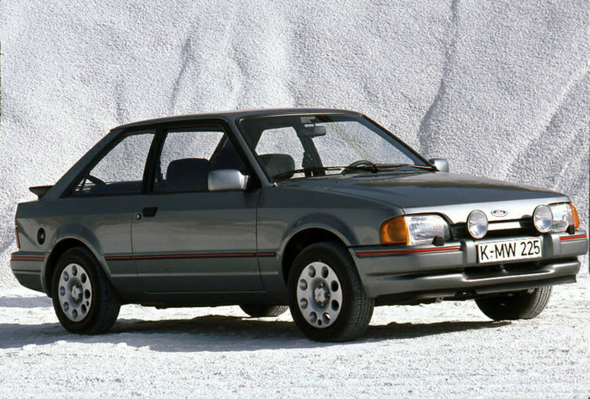 This archival image documents the 1986 Ford Escort Mark IV XR3i in front of scenic gravel pile and is preserved in the Ford Heritage Vault as part of Ford Motor Company's historic photographic archive. Free for personal, non-commercial use. Ford H...