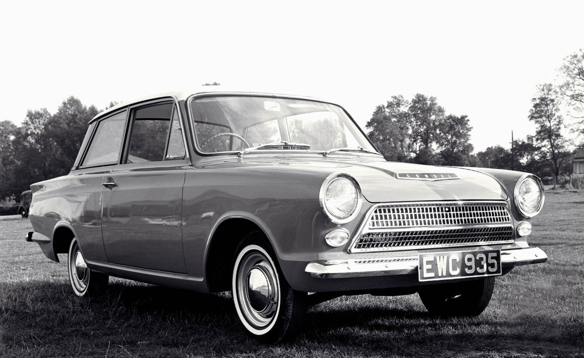 This archival image documents the 1962 Ford Cortina Deluxe MKI front 3/4 view scenic and is preserved in the Ford Heritage Vault as part of Ford Motor Company's historic photographic archive. Free for personal, non-commercial use. Ford Heritage Va...