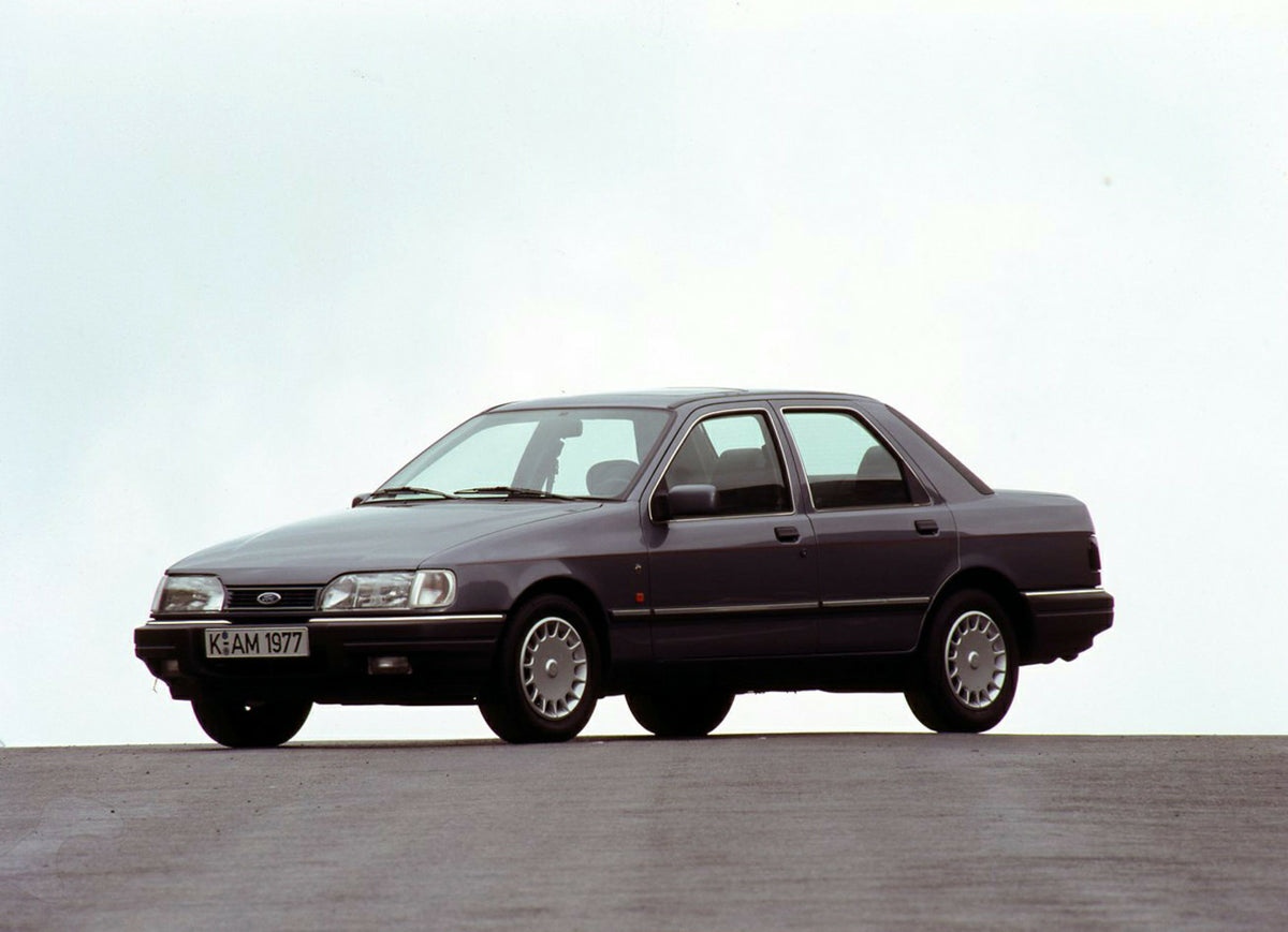 This archival image documents the 1989 Ford Sierra with scenic blue sky and is preserved in the Ford Heritage Vault as part of Ford Motor Company's historic photographic archive. Free for personal, non-commercial use. Ford Heritage Vault reference...