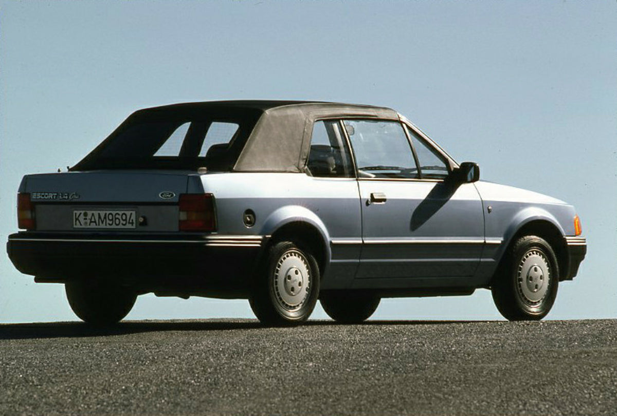 This archival image documents the 1986 Ford Escort Mark IV 1.4 Ghia Cabriolet rear view with scenic blue sky and is preserved in the Ford Heritage Vault as part of Ford Motor Company's historic photographic archive. Free for personal, non-commerci...