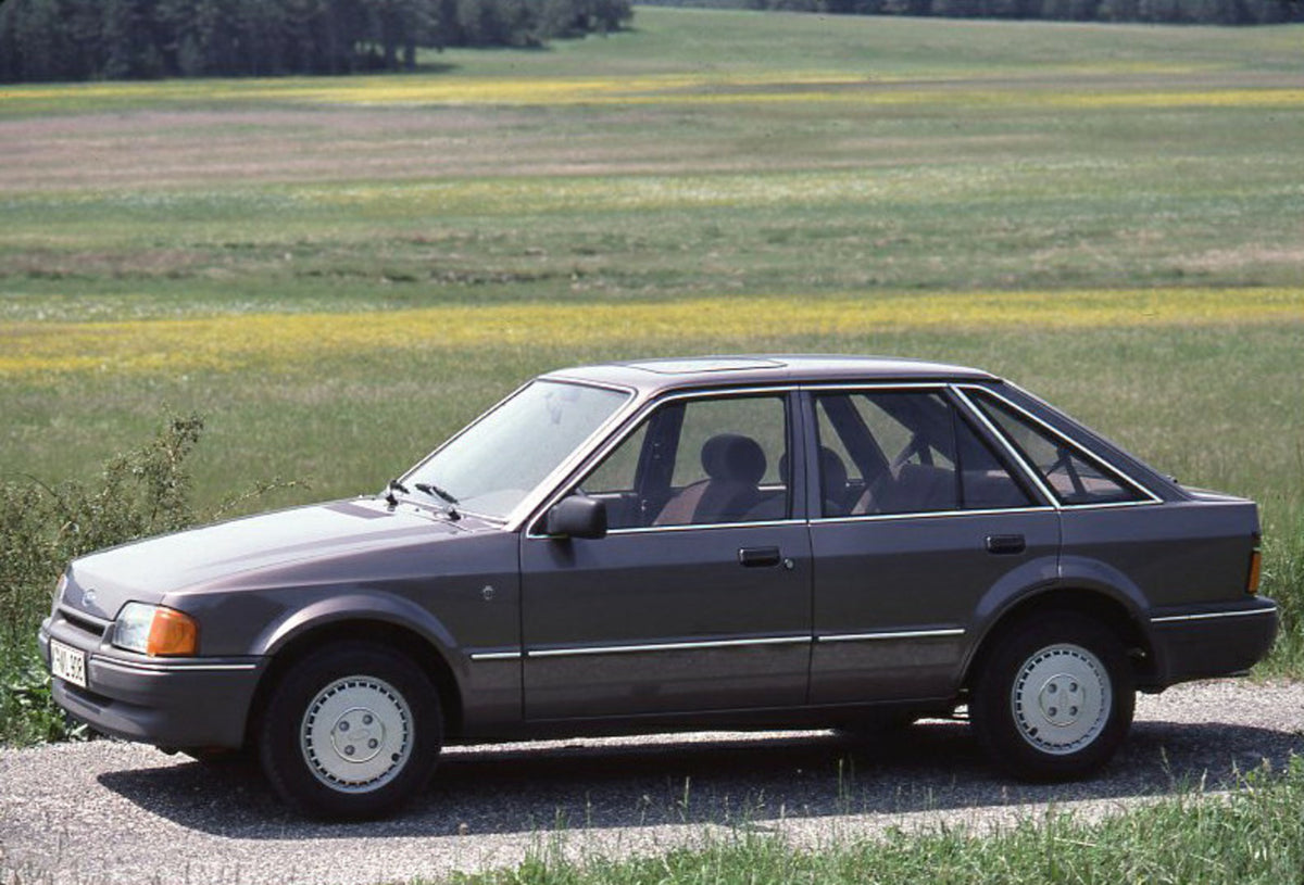 This archival image documents the 1986 Ford Escort Mark IV on scenic road with field and is preserved in the Ford Heritage Vault as part of Ford Motor Company's historic photographic archive. Free for personal, non-commercial use. Ford Heritage Va...
