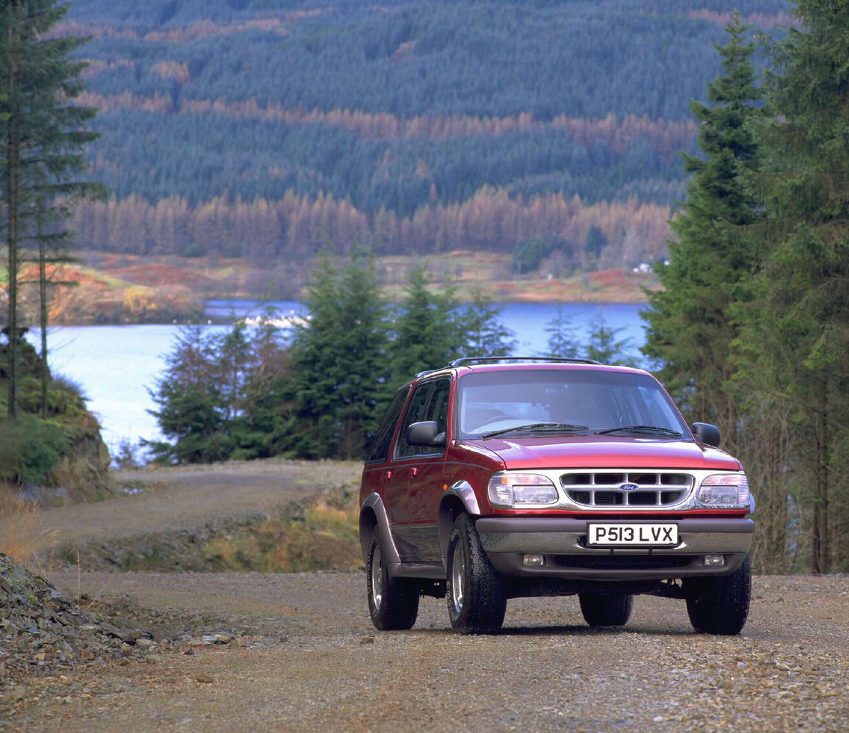 This archival image documents the 1996 Ford Explorer RHD on scenic forest road AR-2002-213709 and is preserved in the Ford Heritage Vault as part of Ford Motor Company's historic photographic archive. Free for personal, non-commercial use. Ford He...