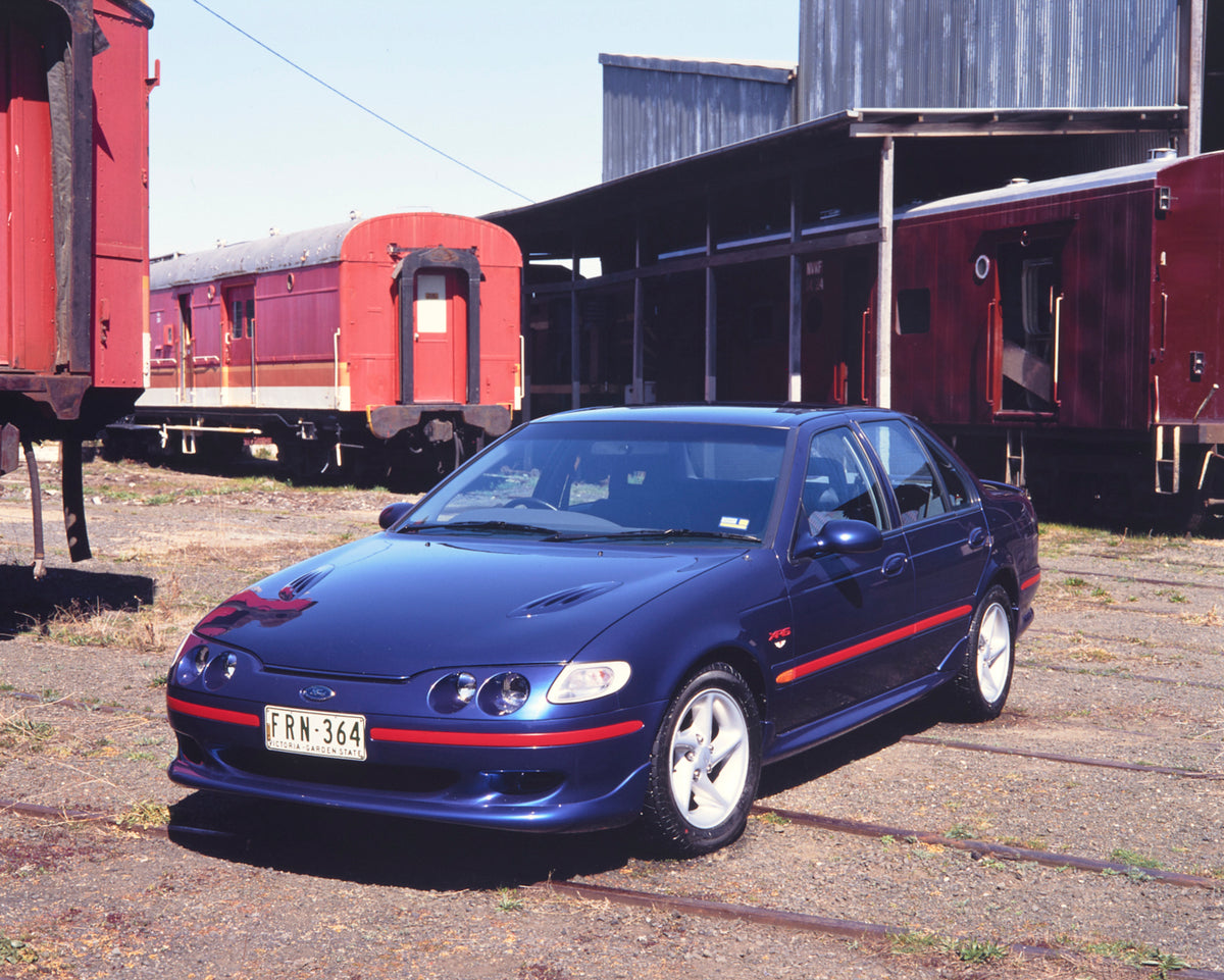 This archival image documents the 1994 Ford Falcon XR6 Sedan Passenger Side Front End View in Trainyard FAP-2011-3 and is preserved in the Ford Heritage Vault as part of Ford Motor Company's historic photographic archive. Free for personal, non-co...