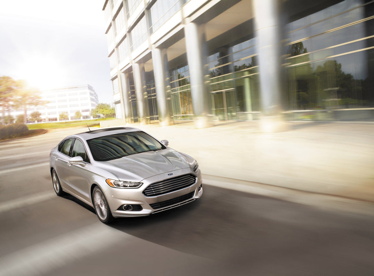This archival image documents the 2015 Ford Fusion action shot in front of building and is preserved in the Ford Heritage Vault as part of Ford Motor Company's historic photographic archive. Free for personal, non-commercial use. Ford Heritage Vau...